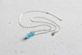 Crystal blue aquamarine beryl on a silver chain. Pendant aquamarine, pendant, decoration on the neck. Natural blue aquamarine on a