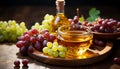 Crystal bowl of grape oil and a glass bottle with corks, amidst clusters of ripe red and green grapes on a wooden platter Royalty Free Stock Photo