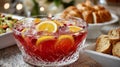 A crystal bowl of punch with orange slices and ice on a table. Royalty Free Stock Photo
