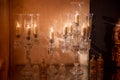 Crystal candlesticks with candles in the form of wine glasses