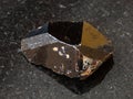 Crystal of Cassiterite Tin ore stone on black Royalty Free Stock Photo