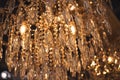 Crystal chandelier close-up. Glamour background with copy space. Warm light and low key image. Royalty Free Stock Photo