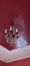 Crystal chandelier hang on red ceiling Royalty Free Stock Photo