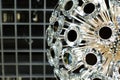 Crystal chandelier with round mirror plates on long tubes, abstract light illumination, geometric background backdrop Royalty Free Stock Photo