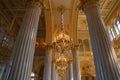 Crystal chandeliers with candels among marble columns. Royalty Free Stock Photo