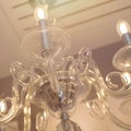 Crystal of classic style chandelier, is a branched ornamental light fixture designed to be mounted on ceilings. Soft warm filter Royalty Free Stock Photo