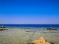 Crystal clear azure water with white beach and palms - paradise coastline coastline of Hurghada, Red Sea, Egypt Royalty Free Stock Photo