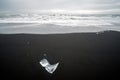 Crystal clear and blue ice chunks washed up on the black lava sand by the waves on diamond beach in Jokulsarlon glacier lagoon. Royalty Free Stock Photo