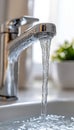 Crystal Clear Flow Modern Chrome Faucet Splashes Refreshing Water into Sink, Space for Text. Royalty Free Stock Photo