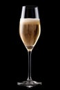 A crystal-clear flute glass of champagne isolated on black background