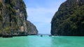 Crystal clear green turquoise water, tropical islands and tourist/longtail boats at Krabi, Andaman sea, Thailand