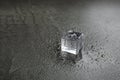Crystal clear ice cube on grey table. Space for text Royalty Free Stock Photo