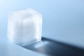 Crystal clear ice cube on light blue background, closeup. Space for text Royalty Free Stock Photo