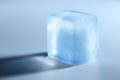Crystal clear ice cube on light blue background, closeup. Space for text Royalty Free Stock Photo