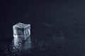 Crystal clear ice cube with water drops on black background. Space for text Royalty Free Stock Photo