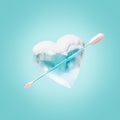 an ice heart with an arrow sticking out of it on a blue background Royalty Free Stock Photo