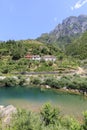 Crystal clear river with a typical Albanian house in the Dinaric Alps of Albania