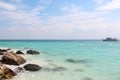 Crystal clear sea of tropical island with a small boat on the horizon, Thailand