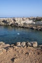 Crystal clear sea water in small rocky bay near Fig tree beach in Protaras, Cyprus Royalty Free Stock Photo