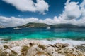 Crystal clear transparent blue turquoise teal Mediterranean sea water in Fiskardo town. White yacht in open sea at Royalty Free Stock Photo