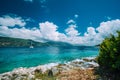 Crystal clear transparent blue turquoise teal Mediterranean sea water in Fiskardo town. White yacht in open sea at Royalty Free Stock Photo