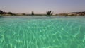 Transparent and crystal clear water with sun reflections in an infinity pool. Royalty Free Stock Photo