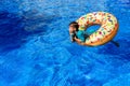 Crystal clear water pool where a child enjoys fun baths during their vacations