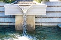 Crystal clear water pouring out of staircase waterfall into pool at botanical gardens - closeup Royalty Free Stock Photo