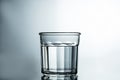 Crystal clear water. Purified water in a glass on a gray background. Pure water concept Royalty Free Stock Photo