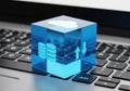 Crystal cloud computing icon rests on a laptop keyboard Royalty Free Stock Photo