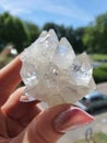 Crystal cluster in womans hand on the balcony Royalty Free Stock Photo