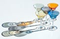 Crystal colorful stemware set with reflection over white background. Colourful elite set of empty alcohol liquor glasses