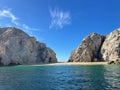 Crystal creal water with rocky mountains in the shore in the background on a sunny day Royalty Free Stock Photo