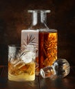 Crystal decanter and glass with whiskey and ice Royalty Free Stock Photo