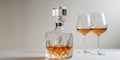 Crystal decanter holding amber liquid with wine glasses in background Royalty Free Stock Photo