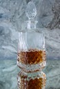 Crystal decanter with whiskey on a gray background Royalty Free Stock Photo