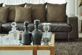 Crystal drink set and sandglass on glass top table in the living room