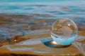 Crystal Earth globe on seashore background Royalty Free Stock Photo