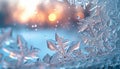 Crystal frost patterns on a windowpane with a warm sunrise glow in the backdrop Royalty Free Stock Photo