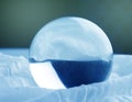 Crystal glass ball sphere transparent on blue gradient background Royalty Free Stock Photo