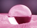 Crystal glass ball sphere transparent on pink gradient background
