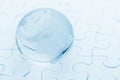 Crystal glass globe ball on puzzle Royalty Free Stock Photo