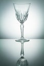 Crystal glass with reflection on white illuminated background