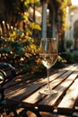 Crystal glass of sparkling wine or champagne on a table at sunlit summer terrace in a vintage style. Summer drinks concept Royalty Free Stock Photo