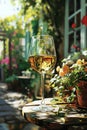 Crystal glass of sparkling wine or champagne on a table at sunlit summer terrace in a vintage style. Summer drinks concept Royalty Free Stock Photo