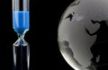 Crystal globe and blue hourglass Royalty Free Stock Photo