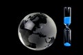 Crystal globe and hourglass Royalty Free Stock Photo