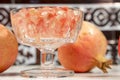 Crystal goblet full of white pomegranate grains, beside several fruits