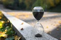 Crystal hourglass with black sand outdoors