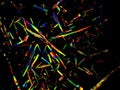 Crystal layer on microscope object glass, seen in polarized light. This causes random unforeseeable color effects